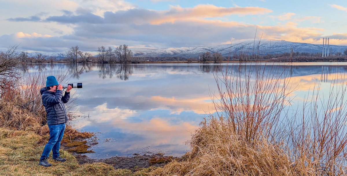 Joseph birding at a lake at sunset